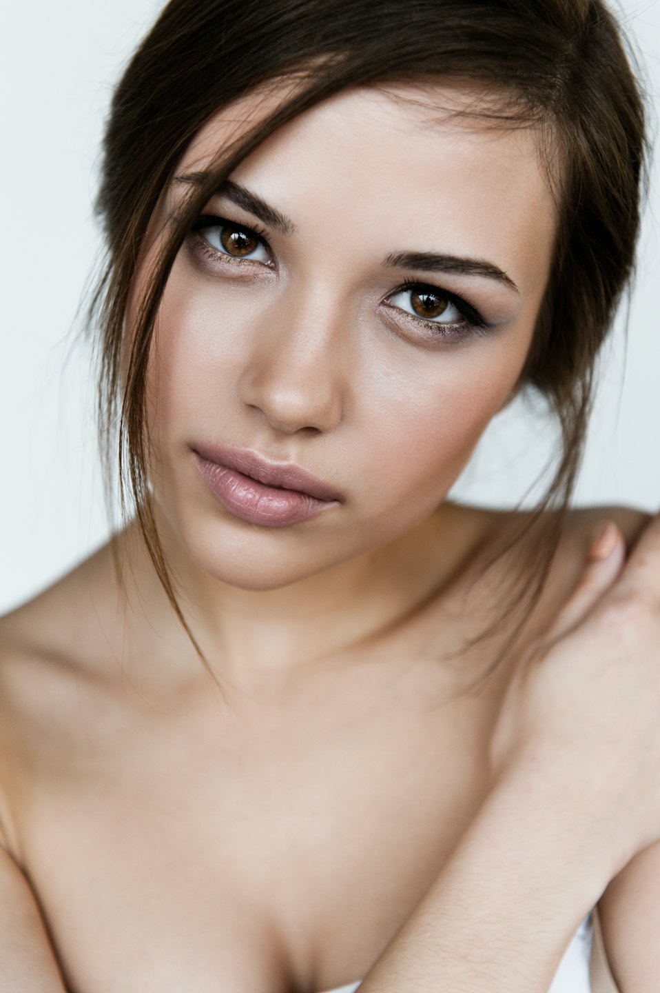 Young East Asian woman with dark brown hair looking forward.