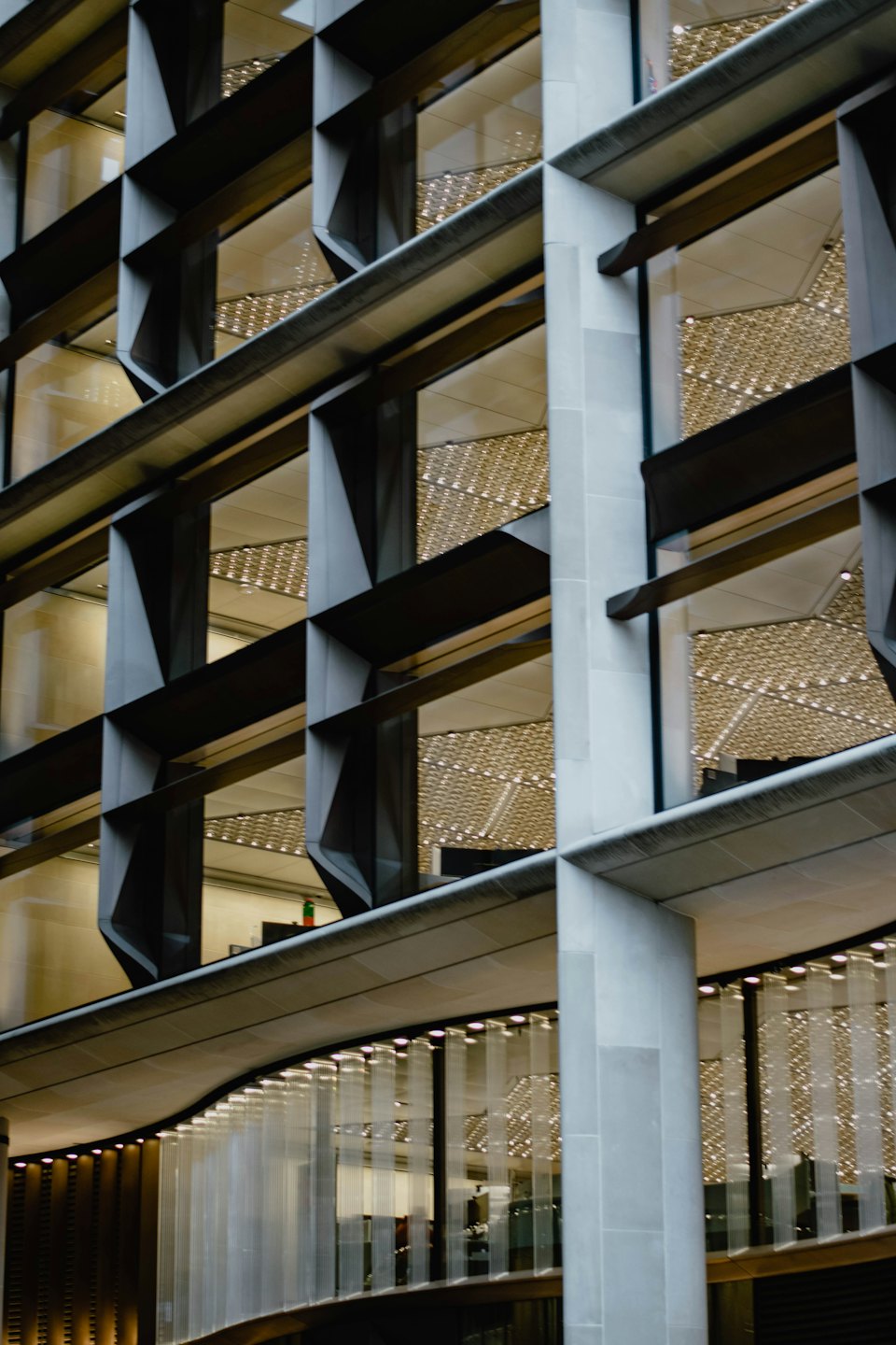 Modern corporate building facade with repeating metal panels and glass windows.
